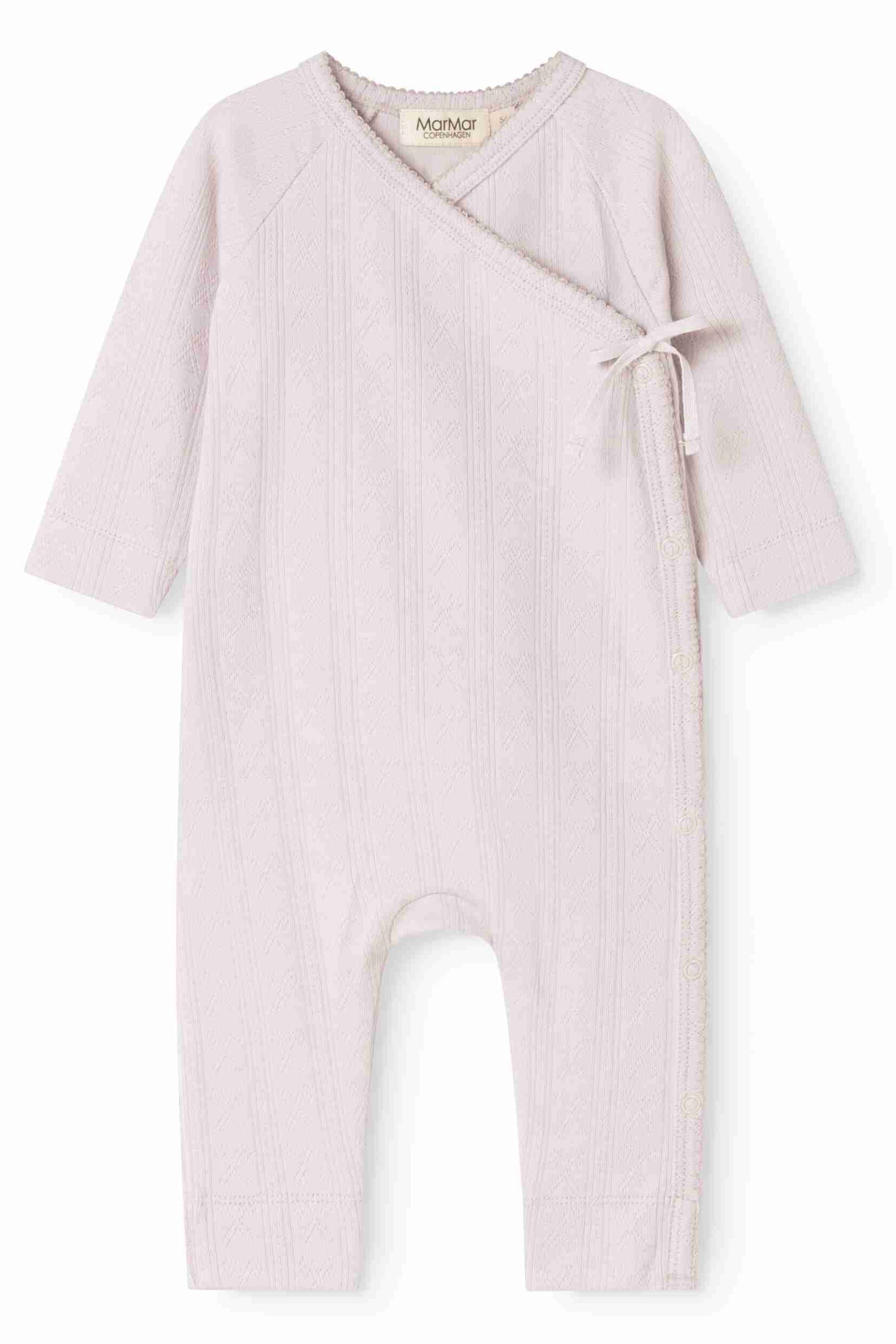 A light pink ribbed cotton baby jumpsuit with a wrap-around front, long sleeves, and a small side bow, shown on a plain white background.
