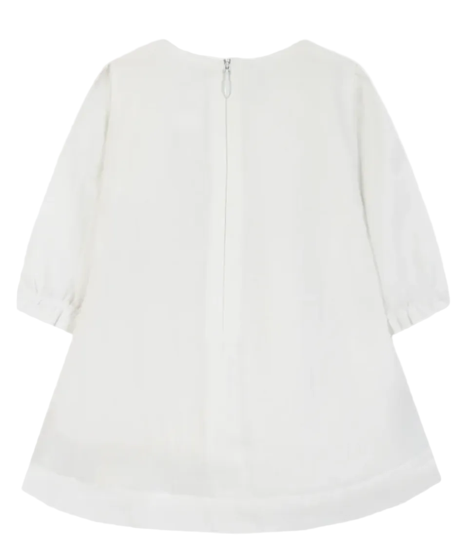 White long-sleeve blouse shown from the back, featuring a round neckline, a central zipper, gathered elbow-length sleeves, and a curved hem.