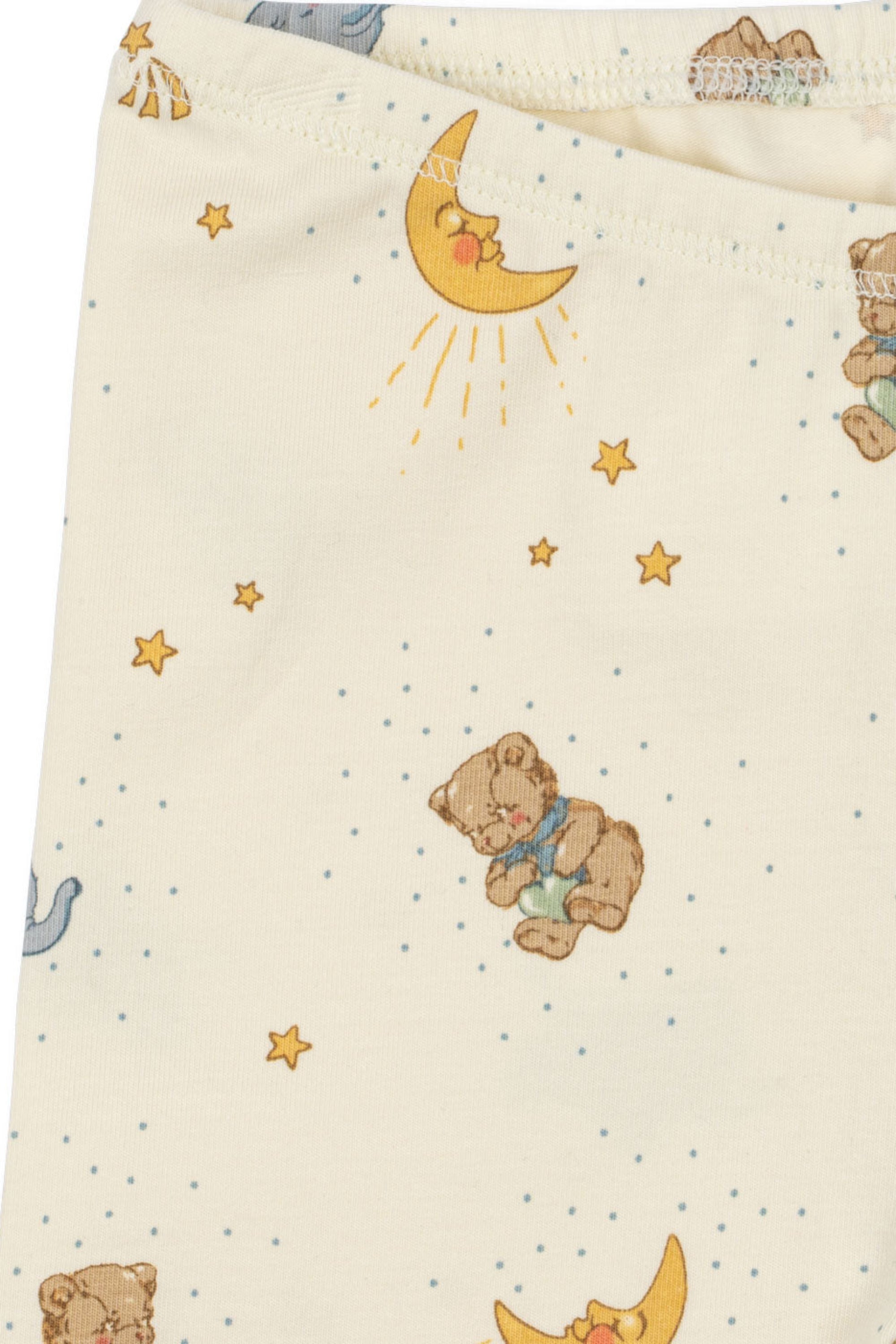 Baby blanket with teddy bear and celestial pattern on a beige background
