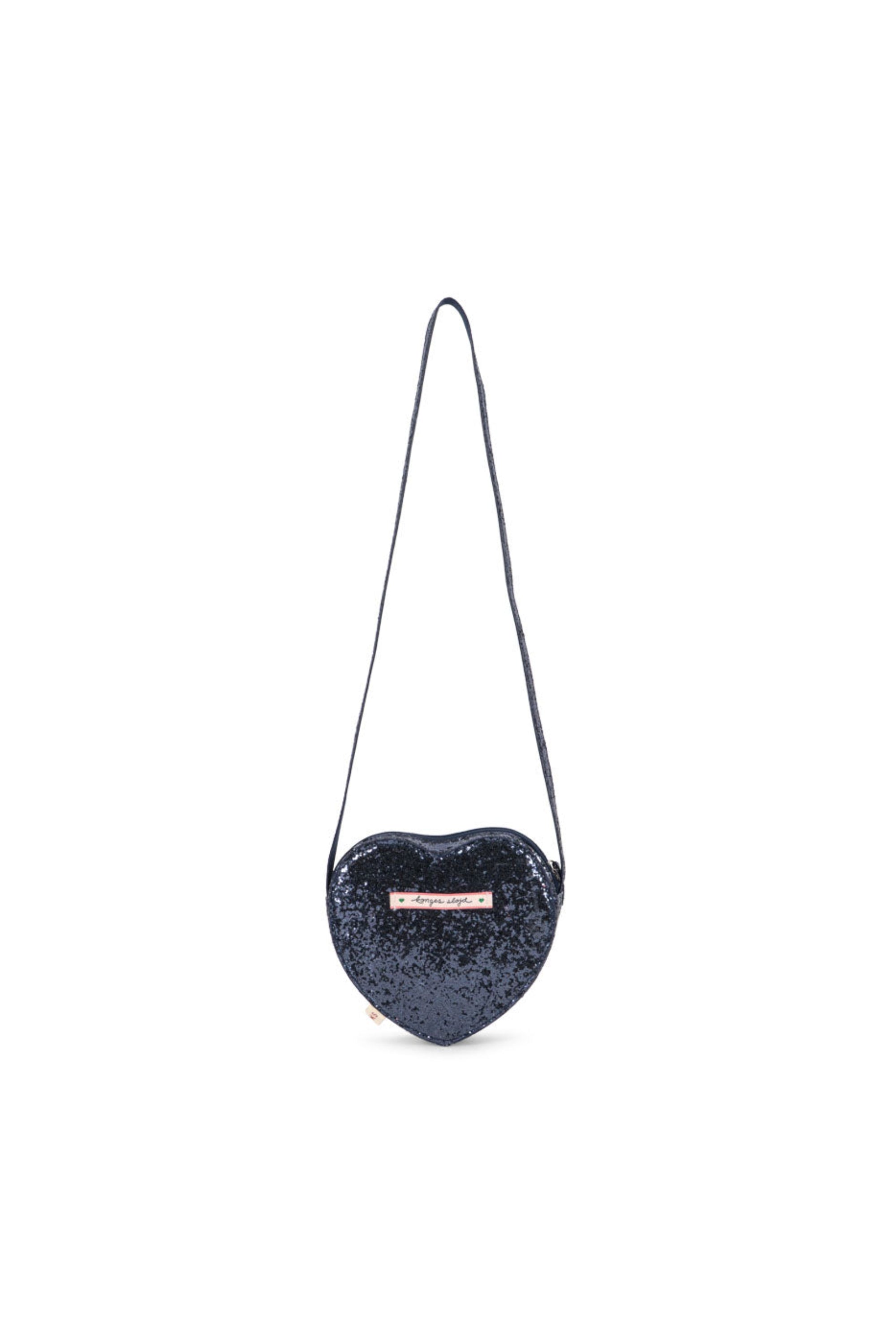 A heart-shaped navy blue sequined shoulder bag with a thin black strap and a small white brand label on the front, set against a plain white background.