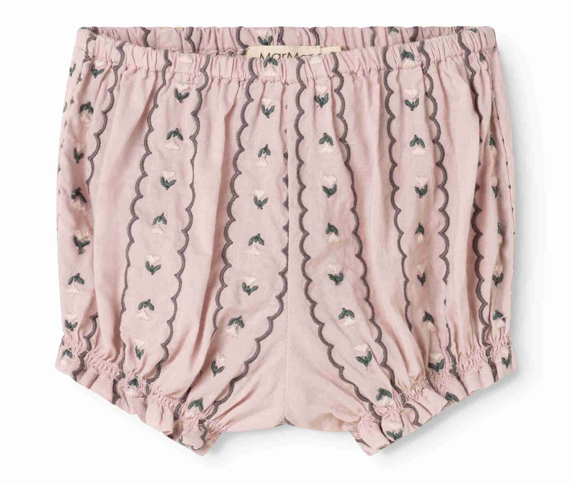 Pink cotton bloomers with vertical scalloped stripes and small embroidered floral details, featuring an elastic waistband and ruffled leg hems.