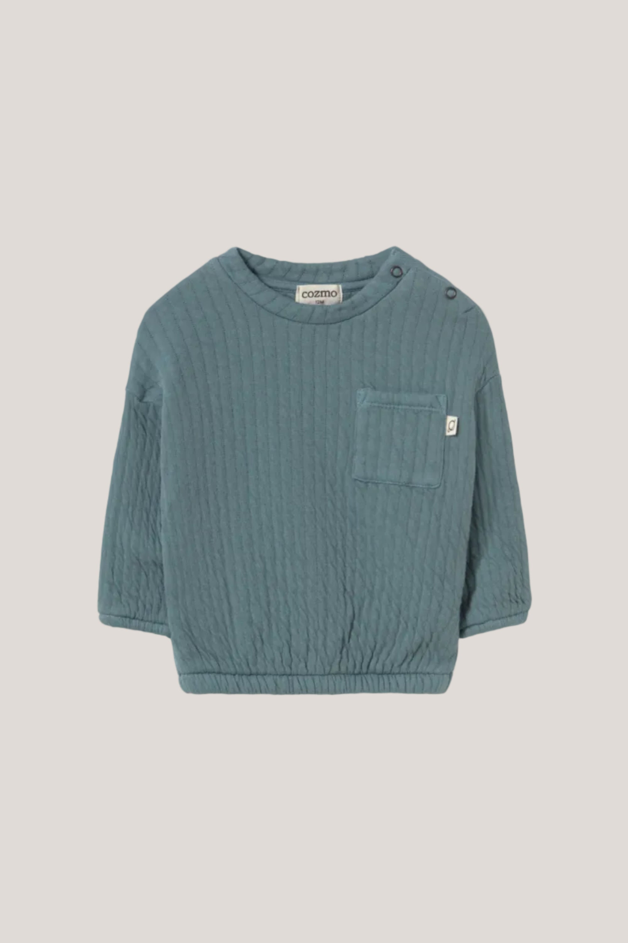Teal ribbed sweater with a pocket on a light gray background
