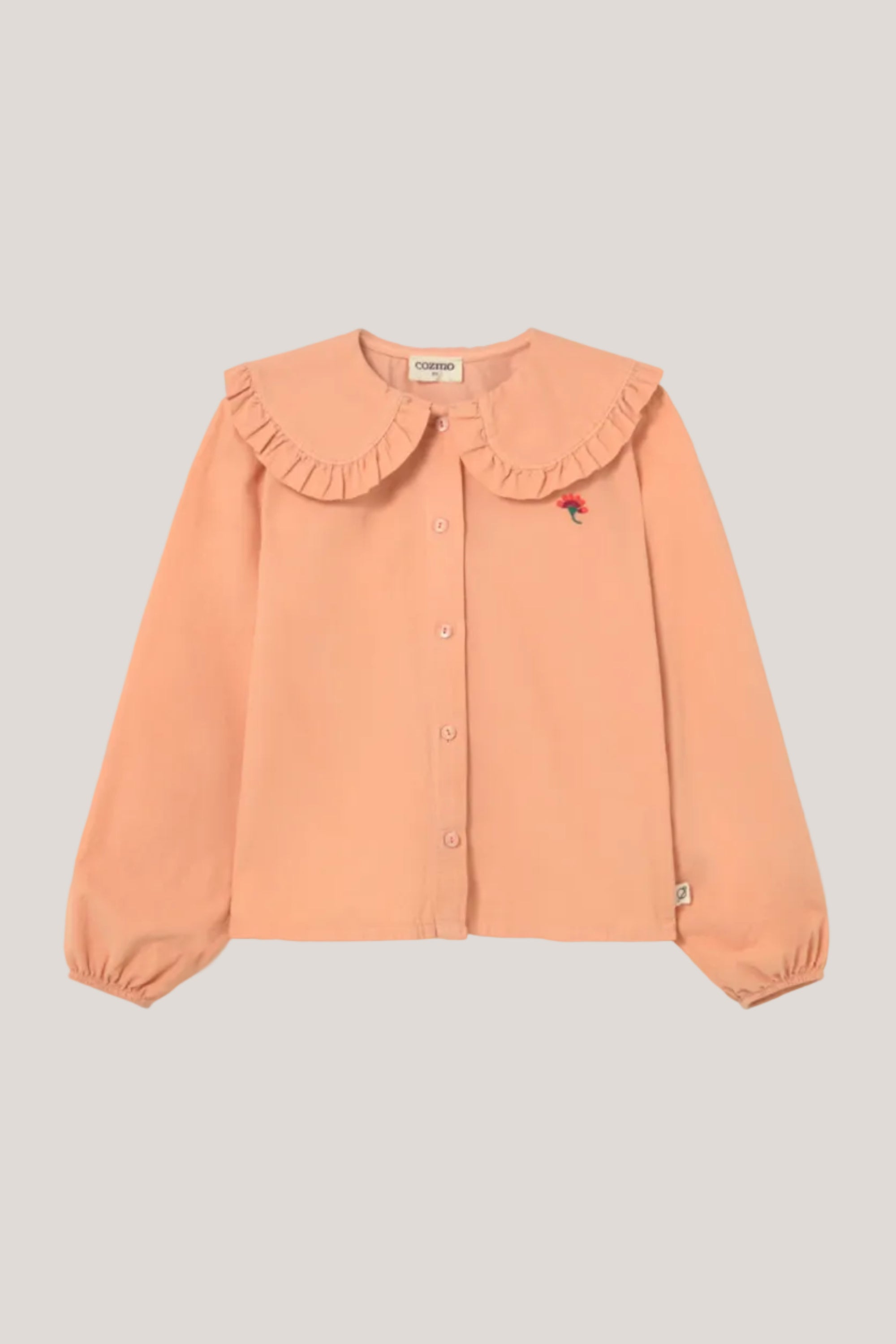 Peach-colored blouse with ruffled collar on a light gray background