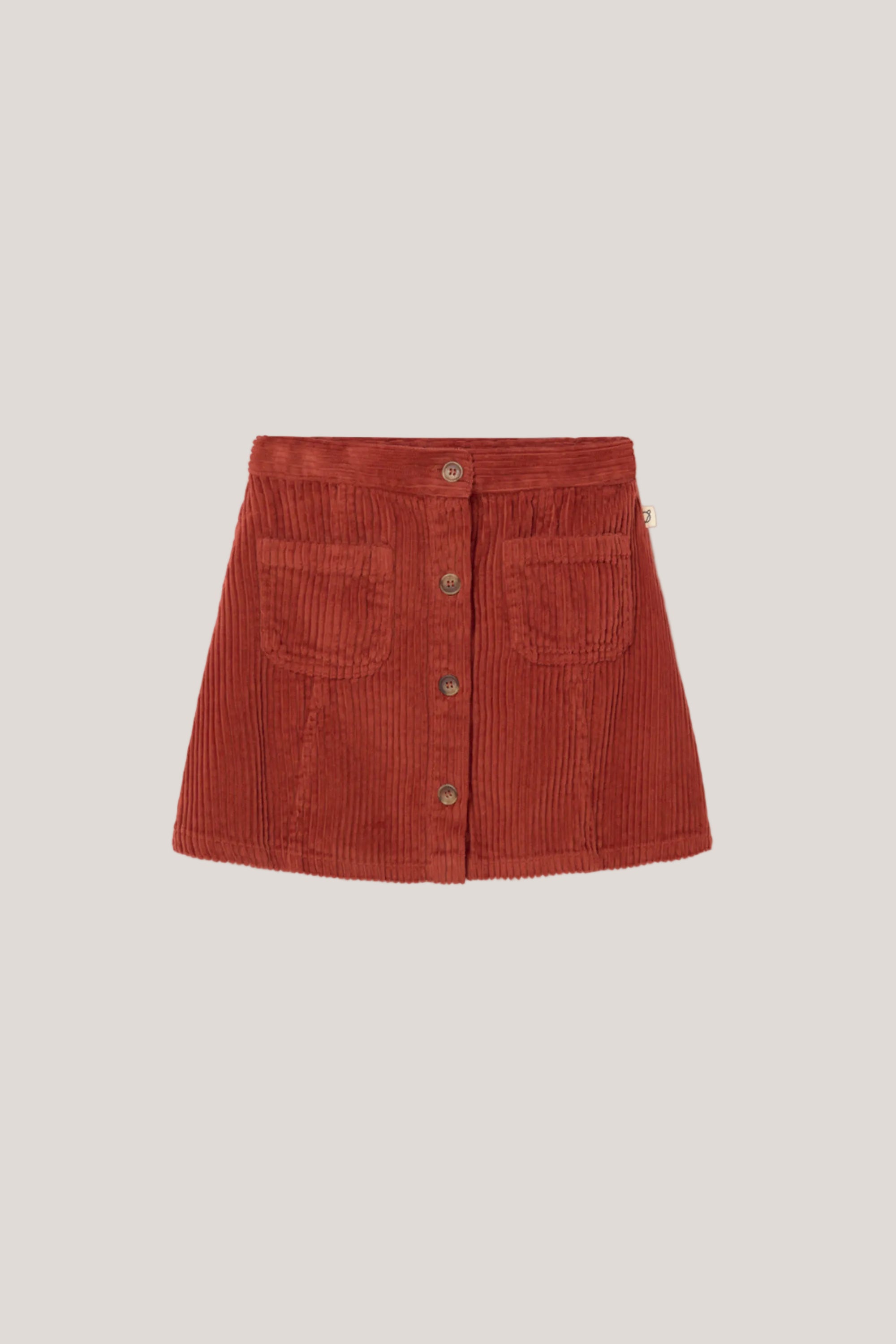 Red corduroy skirt on a light gray background