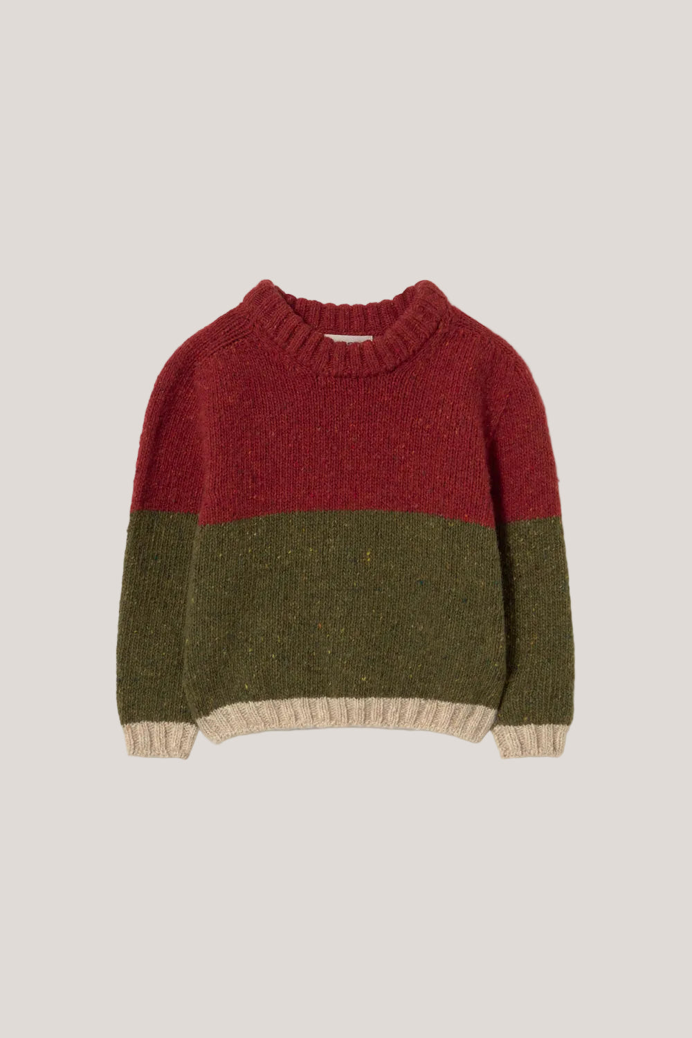 Three-tone sweater with red, green, and beige sections on a light gray background
