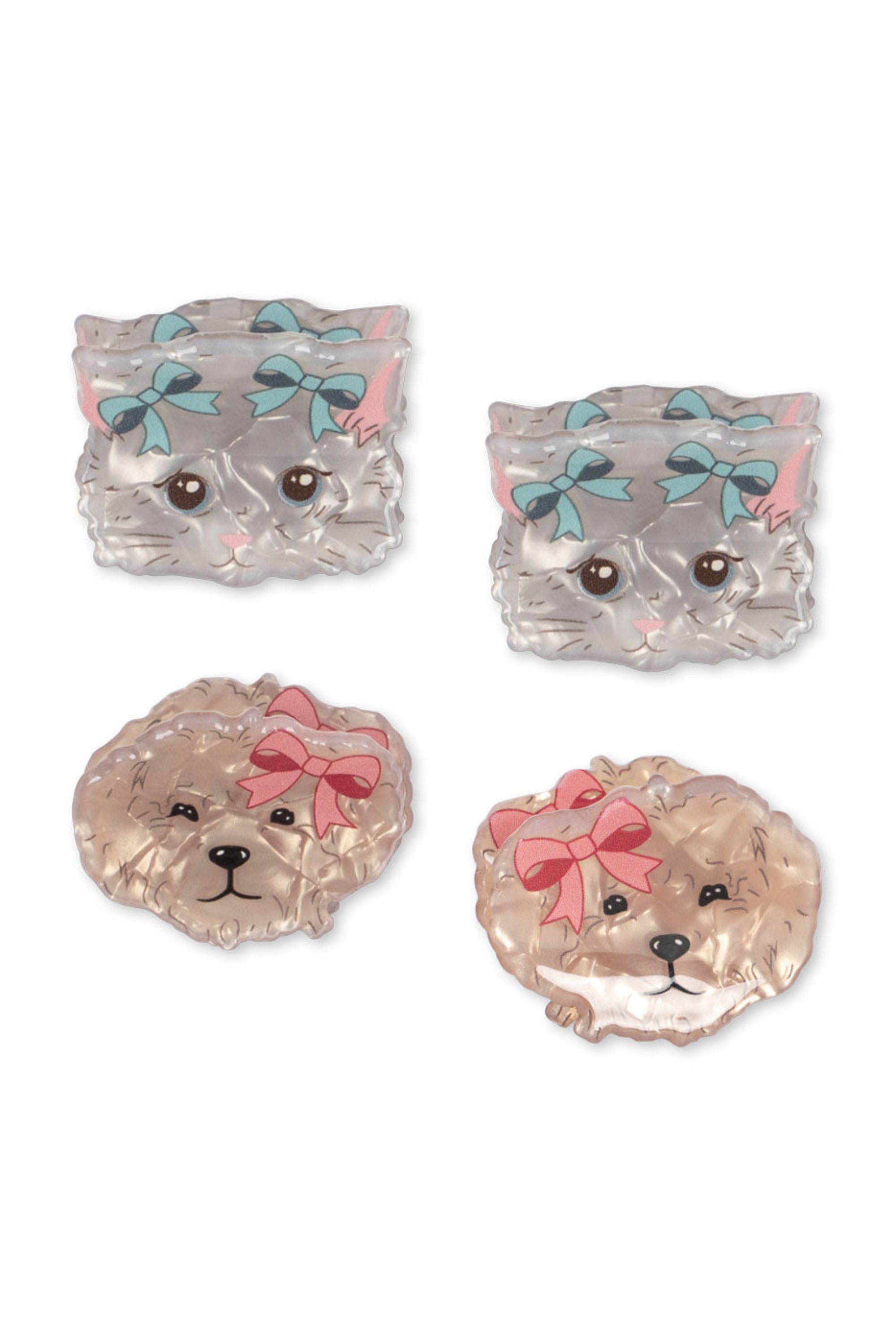Four dog-shaped coasters with bows on a white background